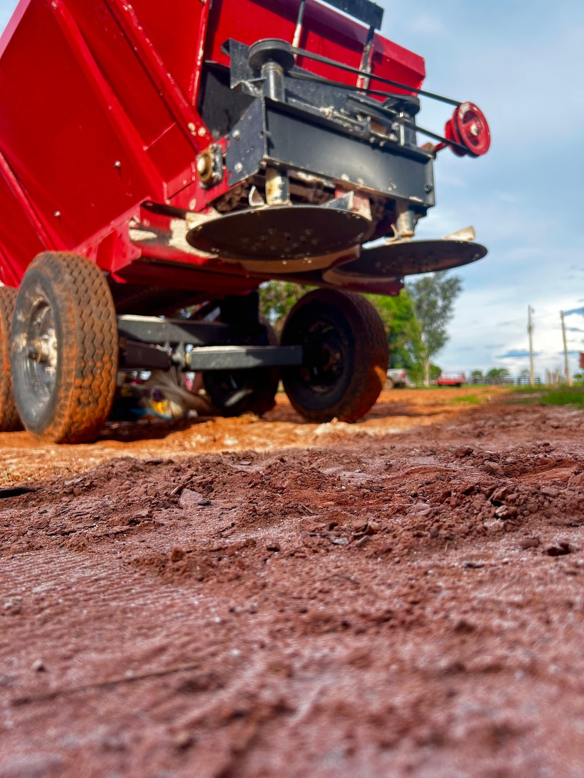 Adjustment of lime application equipment on agricultural field.