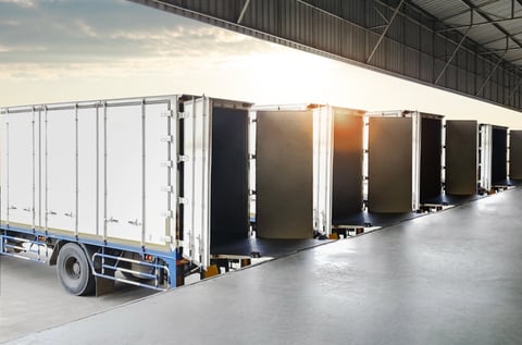 Row of Container Trucks Loading Dock at Warehouse. Shipping Cargo Container.