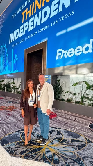 Two people standing at Caesars Forum in Las Vegas for the Worlds Thinking Independent event, July 9-11, 2026