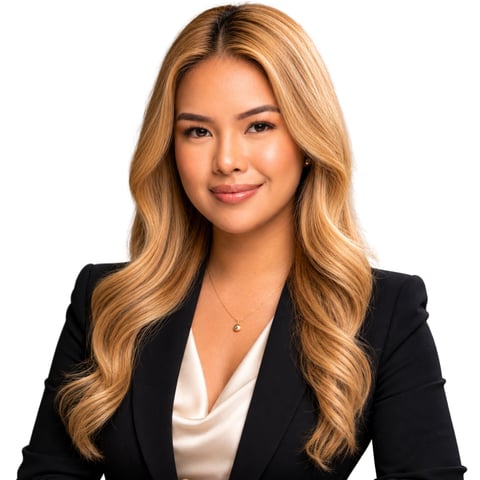 Professional headshot of woman with long honey blonde wavy hair wearing black blazer and white blouse against white background